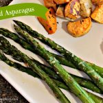 The words "Roasted Asparagus" over a white dinner plate that has steak, potatoes, and asparagus