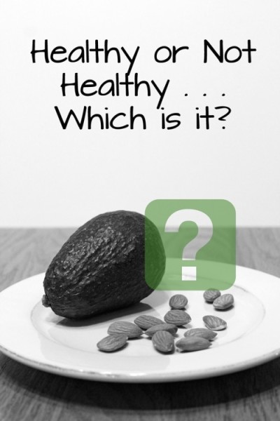 The words "Healthy or Not Healthy . . . Which is it?" above a plate containing an avocado and some almonds
