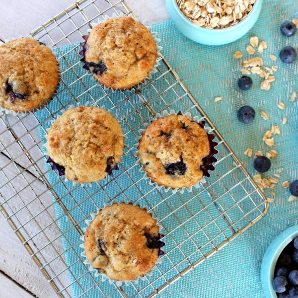 Overhead photo of five Blueberry Oat Muffins on a cooling rack