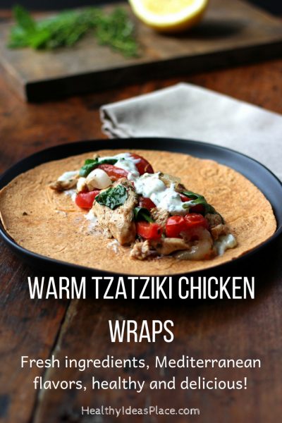 Warm Tzatziki Chicken Wrap unrolled on a black plate