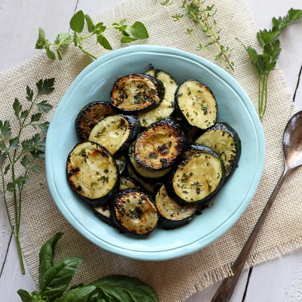 Grilled zucchini slices in a teal colored bowl