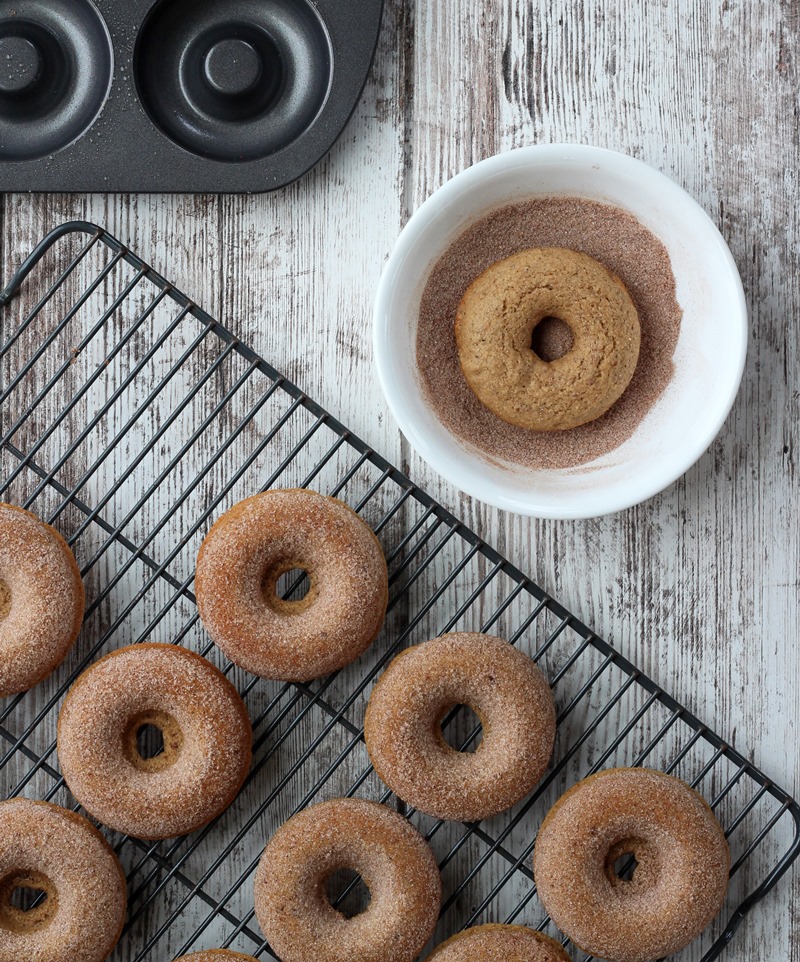 donuts on cooling rack and in bowl with sugar