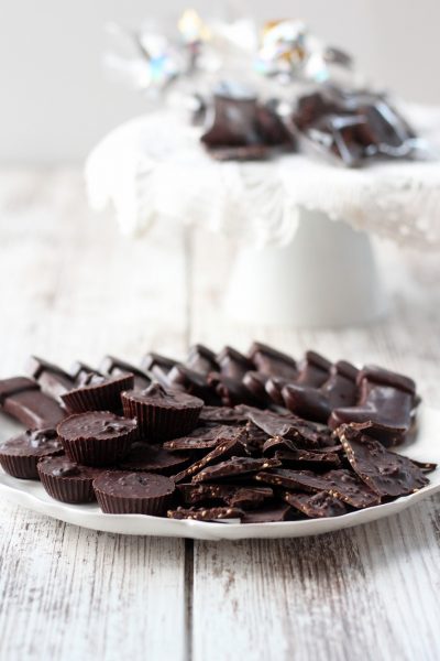 homemade dark chocolate candies on a white plate with a white background
