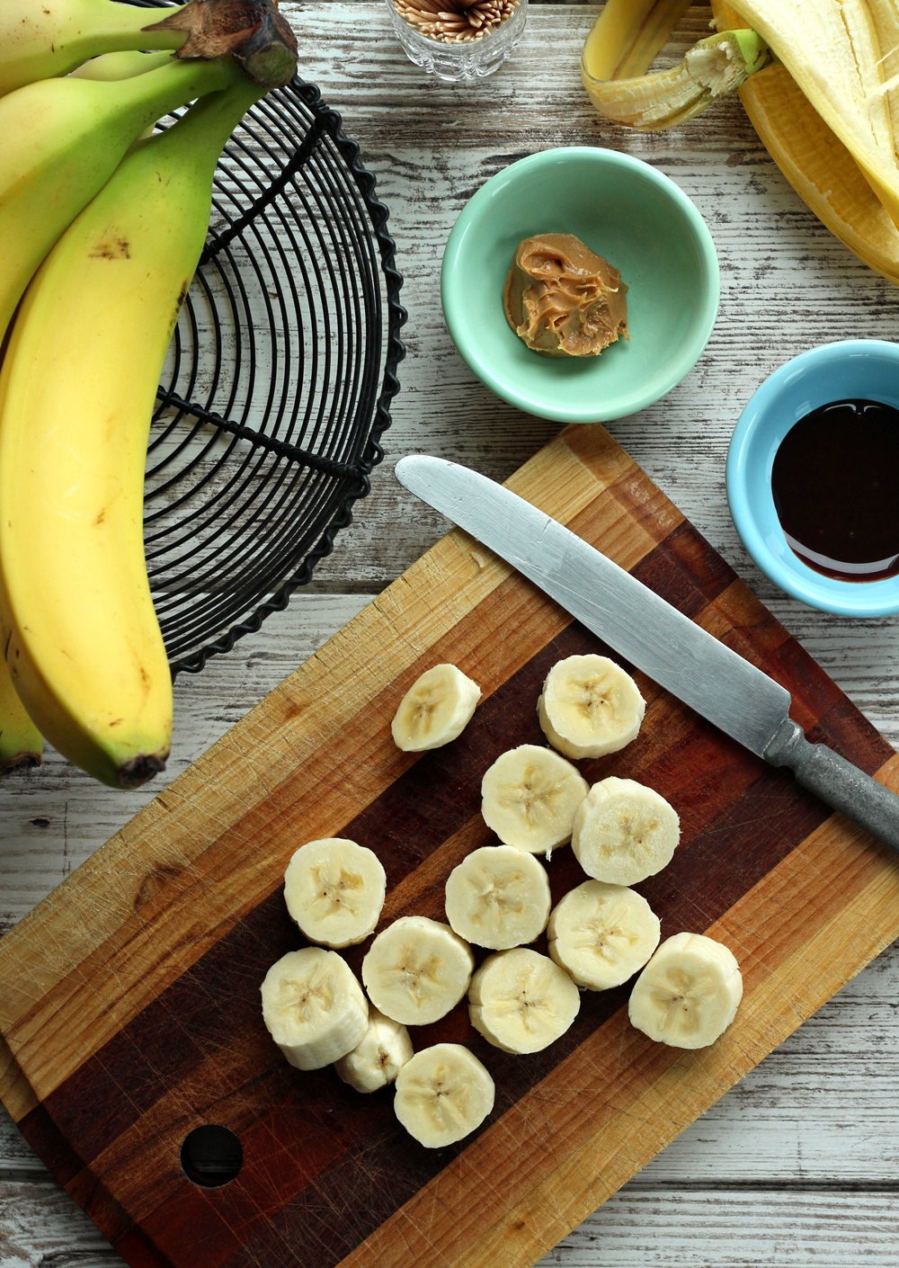 Banana slices on wooden cutting board